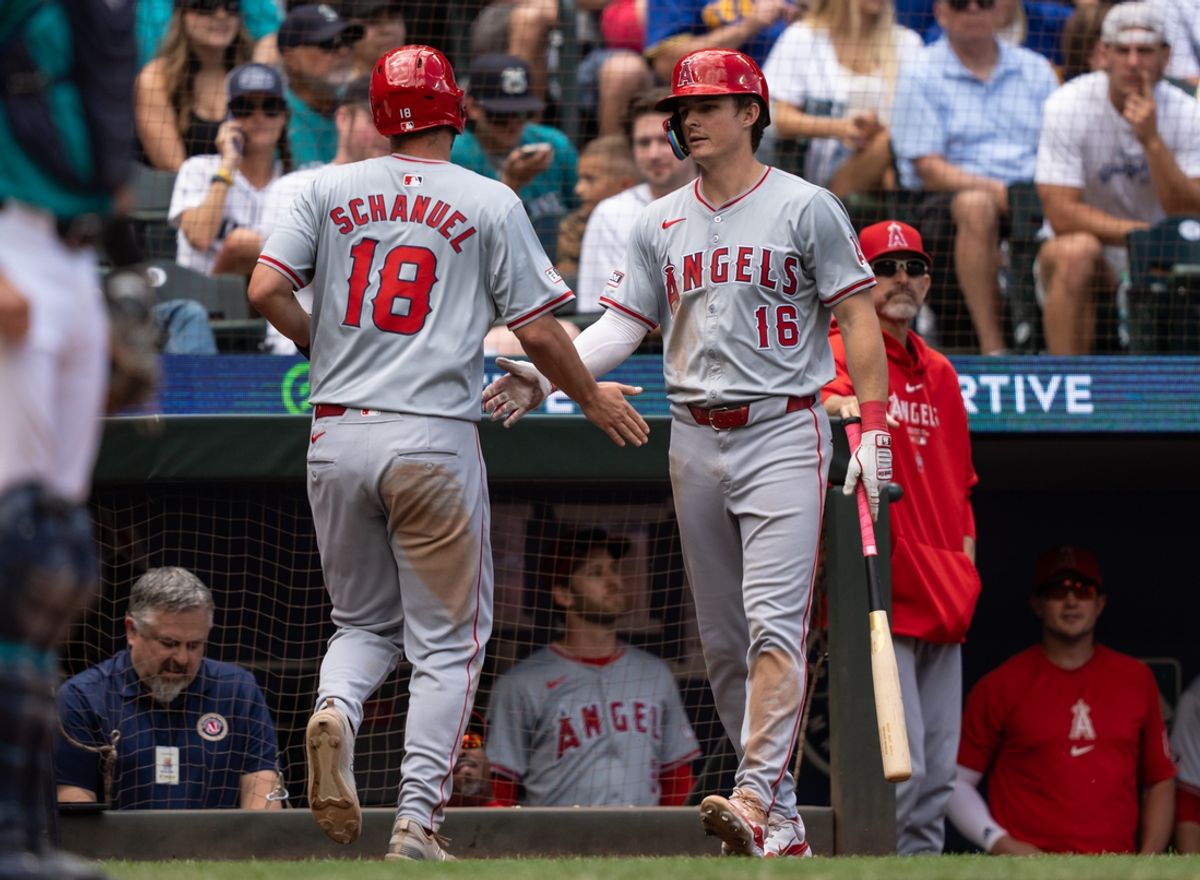 Jul 24, 2024; Seattle, Washington, USA;  Los Angeles Angels first baseman Nolan Schanuel (18) is congratulated by centerfielder Mickey Moniak (16) after scoring a run during the eighth inning at T-Mobile Park. Mandatory Credit: Stephen Brashear-USA TODAY Sports