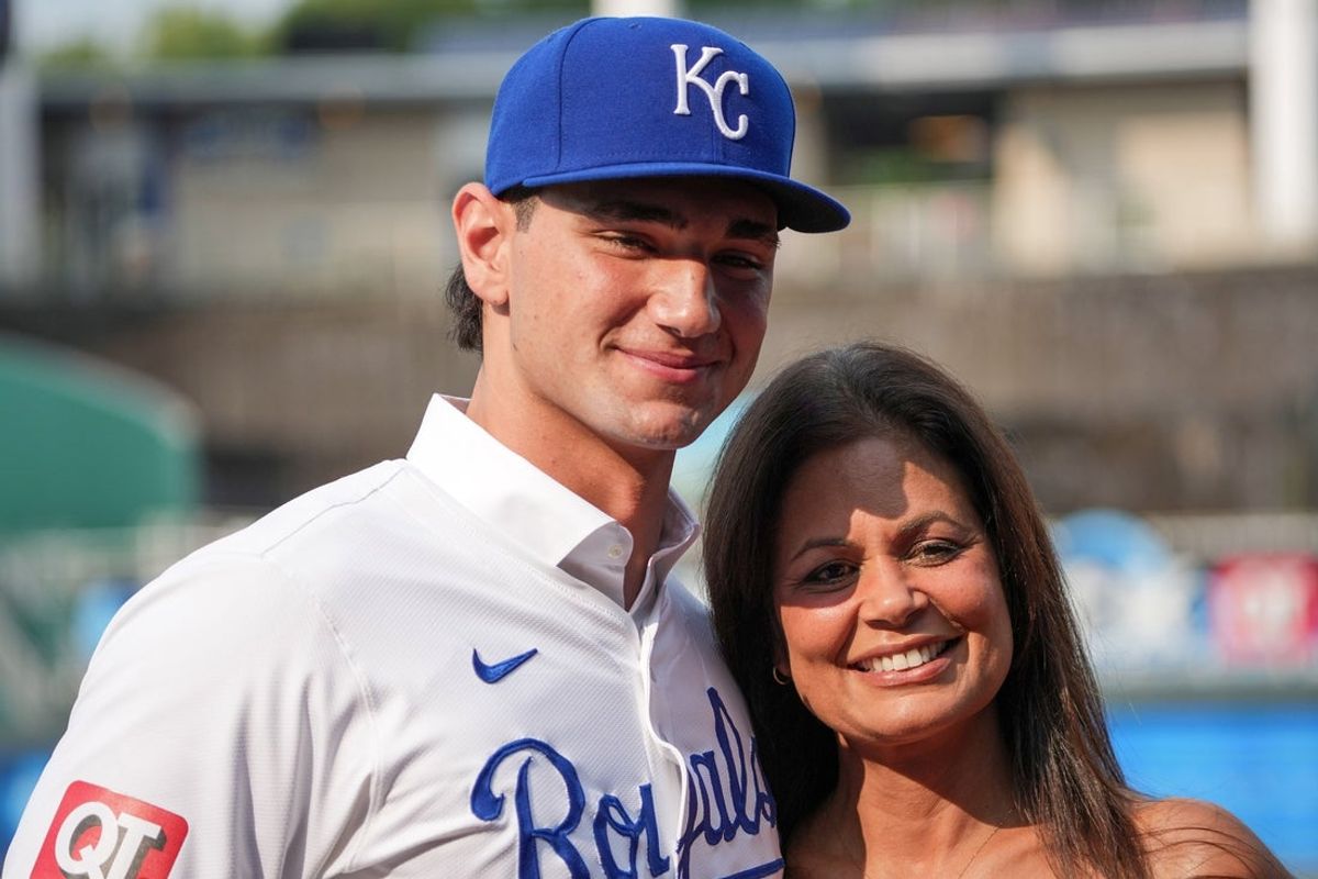 Jul 24, 2024; Kansas City, Missouri, USA; Kansas City Royals first round draft pick Jac Caglianone poses with his mother Johanne Caglianone for photos on the field prior to a game against the Arizona Diamondbacks at Kauffman Stadium. Mandatory Credit: Denny Medley-Imagn Images