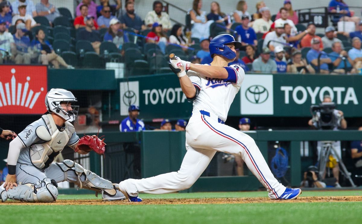 Jul 24, 2024; Arlington, Texas, USA; Texas Rangers shortstop Corey Seager (5) singles during the eighth inning against the Chicago White Sox at Globe Life Field. Mandatory Credit: Kevin Jairaj-USA TODAY Sports