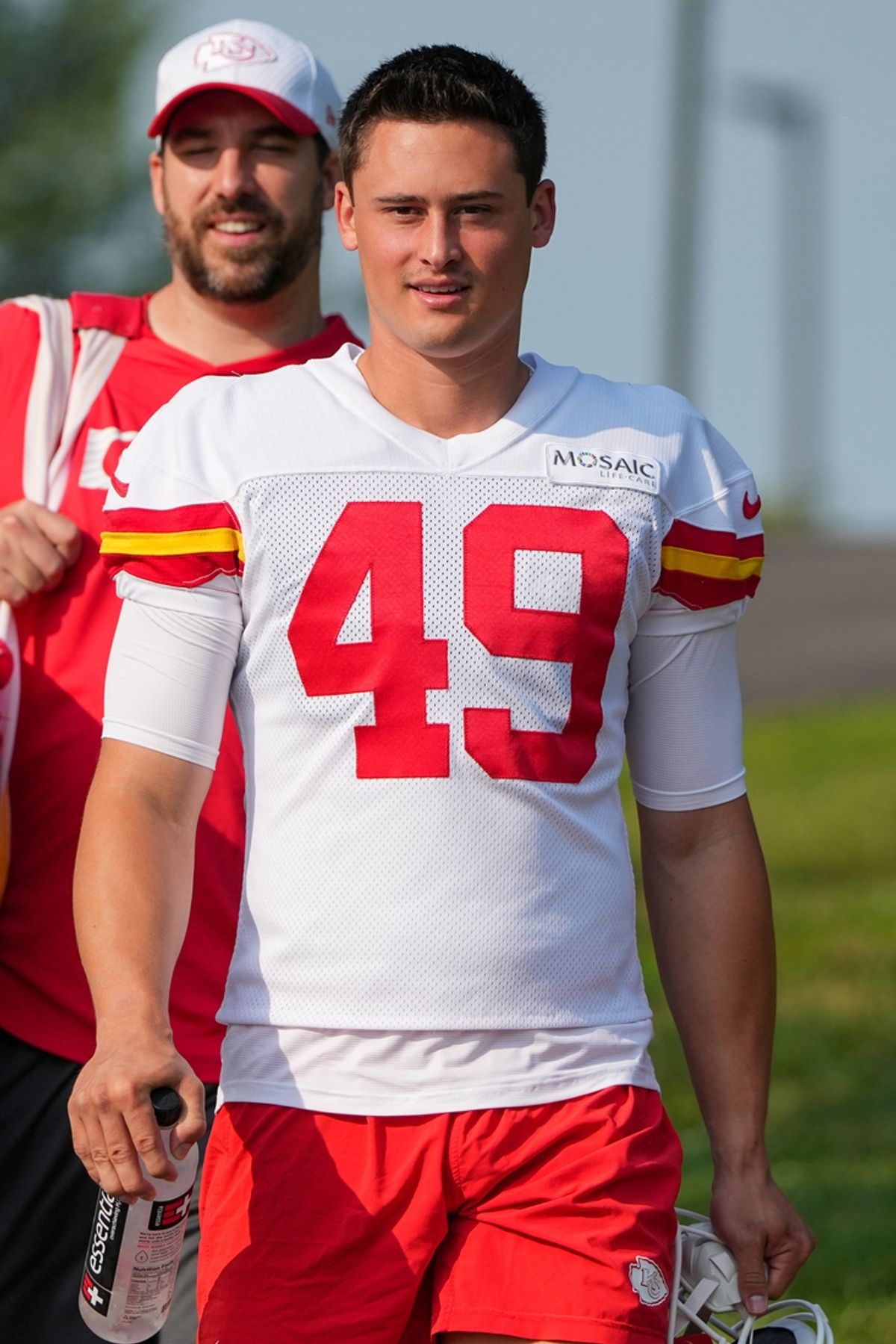Jul 22, 2024; St. Joseph, MO, USA; Kansas City Chiefs punter Matt Araiza (49) walks down the hill from the locker room to the fields prior to training camp at Missouri Western State University. Mandatory Credit: Denny Medley-USA TODAY Sports