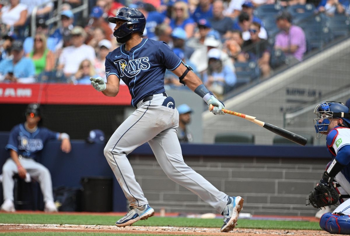 Jul 25, 2024; Toronto, Ontario, CAN; Tampa Bay Rays third baseman Amed Rosario (10) hits a single against the Toronto Blue Jays in the second inning at Rogers Centre. Mandatory Credit: Dan Hamilton-USA TODAY Sports