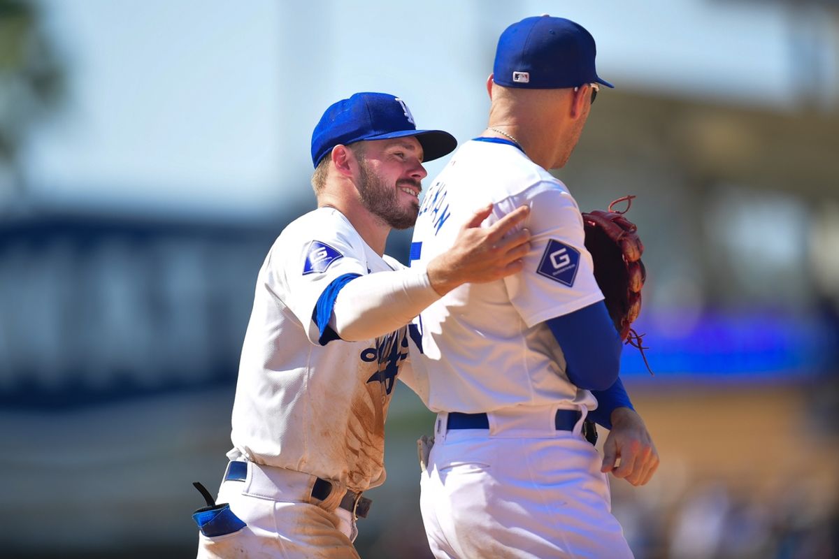 Jul 25, 2024; Los Angeles, California, USA; Los Angeles Dodgers second baseman Gavin Lux (9) and first baseman Freddie Freeman (5) react after a challenge by the San Francisco Giants is overturned during the ninth inning at Dodger Stadium. Mandatory Credit: Gary A. Vasquez-USA TODAY Sports