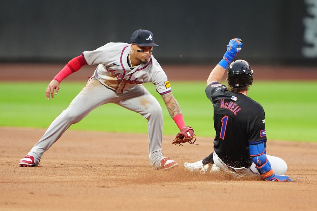 Jul 25, 2024; New York City, New York, USA; Atlanta Braves shortstop Orlando Arcia (11) tags out New York Mets left fielder Jeff McNeil (1) attempting to stretch a single into a double during the second inning at Citi Field. Mandatory Credit: Gregory Fisher-USA TODAY Sports