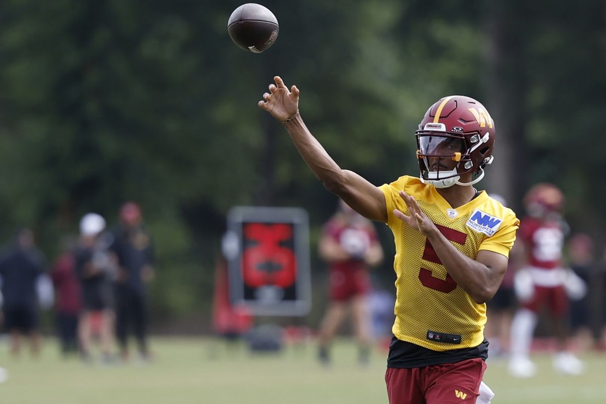 Jul 26, 2024; Ashburn, VA, USA; Washington Commanders quarterback Jayden Daniels (5) passes the ball on day three of training camp at Commanders Park. Mandatory Credit: Geoff Burke-USA TODAY Sports