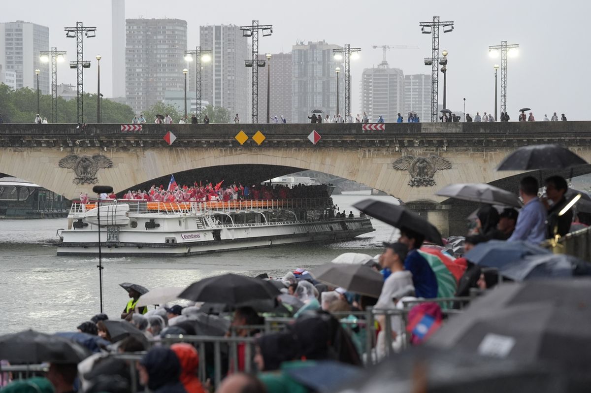 Delegation for Chile makes its way up the Seine as spectators take shelter from rain during the Opening Ceremony for the Paris 2024 Olympic Summer Games along the Seine River. Mandatory Credit: Jabin Botsford/Pool Photo via USA TODAY Sports