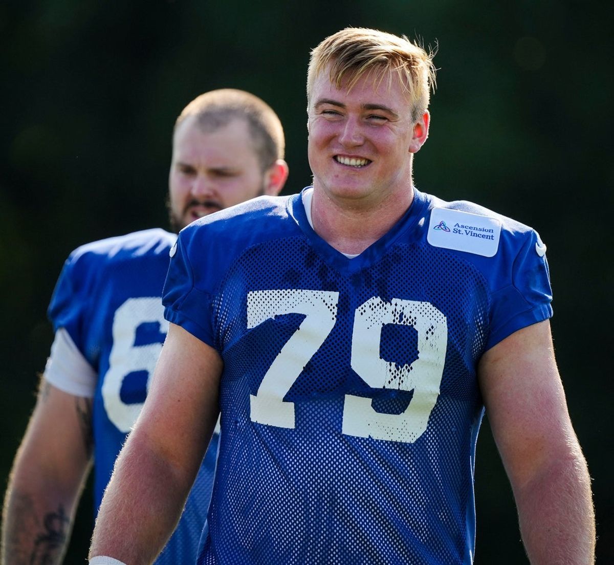 Indianapolis Colts offensive tackle Bernhard Raimann (79) smiles while walking to warm up Saturday, July 27, 2024, during the Indianapolis Colts’ training camp at Grand Park Sports Complex in Westfield.