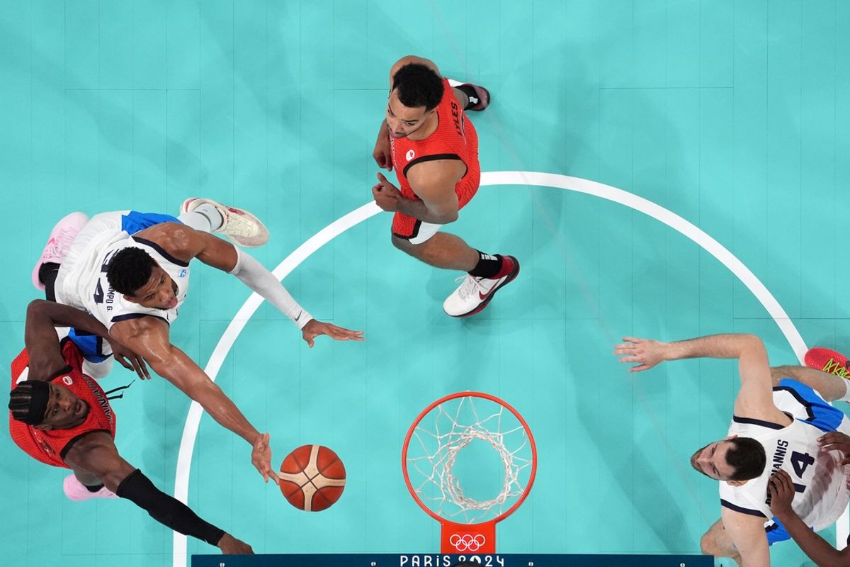 Jul 27, 2024; Villeneuve-d'Ascq, France; Greece small forward Giannis Antetokounmpo (34) shoots against Canada shooting guard Nickeil Alexander-Walker (1) in the first half during the Paris 2024 Olympic Summer Games at Stade Pierre-Mauroy. Mandatory Credit: John David Mercer-USA TODAY Sports