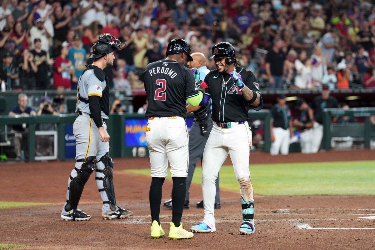 Jul 27, 2024; Phoenix, Arizona, USA; Arizona Diamondbacks second base Ketel Marte (4) celebrates with Arizona Diamondbacks shortstop Geraldo Perdomo (2) after hitting a two run home run against the Pittsburgh Pirates during the second inning at Chase Field. Mandatory Credit: Joe Camporeale-USA TODAY Sports