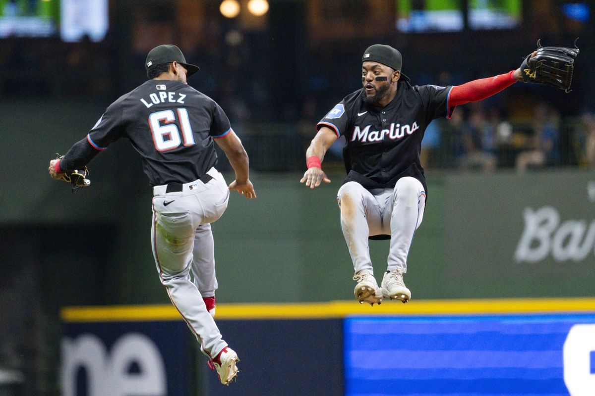 Jul 27, 2024; Milwaukee, Wisconsin, USA;  Miami Marlins second baseman Otto Lopez (61) and shortstop Vidal Brujan (17) high five following the game against the Milwaukee Brewers at American Family Field. Mandatory Credit: Jeff Hanisch-USA TODAY Sports