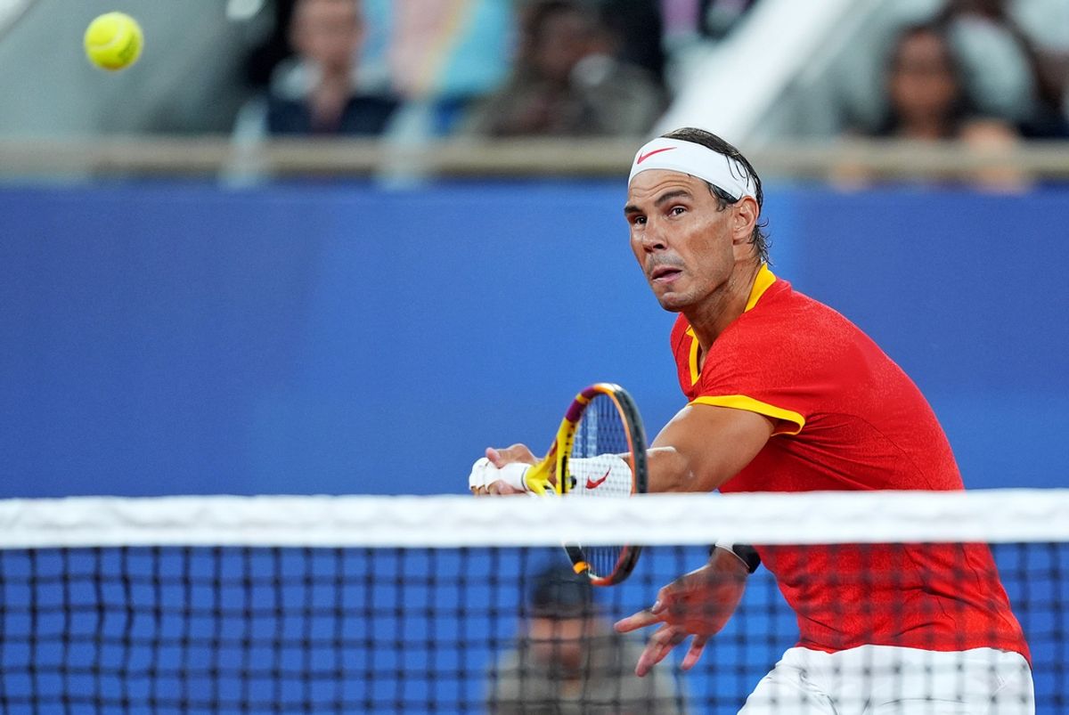 Jul 28, 2024; Paris, France; Rafael Nadal (ESP) returns a ball against Maximo Gonzales (ARG) and Andres Molteni (ARG) in the men's tennis doubles first round during the Paris 2024 Olympic Summer Games at Stade Roland Garros. Mandatory Credit: Amber Searls-USA TODAY Sports