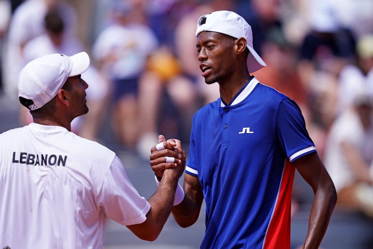 Jul 28, 2024; Paris, France; Christopher Eubanks (USA) shakes hands with Benjamin Hassan (LBN) in the men’s tennis singles first round during the Paris 2024 Olympic Summer Games at Stade Roland Garros. Mandatory Credit: Amber Searls-Imagn Images