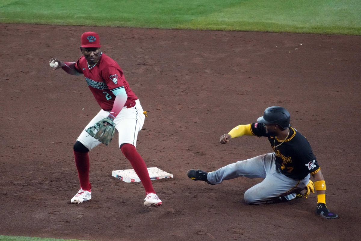 Jul 28, 2024; Phoenix, Arizona, USA; Arizona Diamondbacks shortstop Geraldo Perdomo (2) throws to first base after forcing out Pittsburgh Pirates outfielder Joshua Palacios (77) at second during the sixth inning at Chase Field. Mandatory Credit: Joe Camporeale-USA TODAY Sports