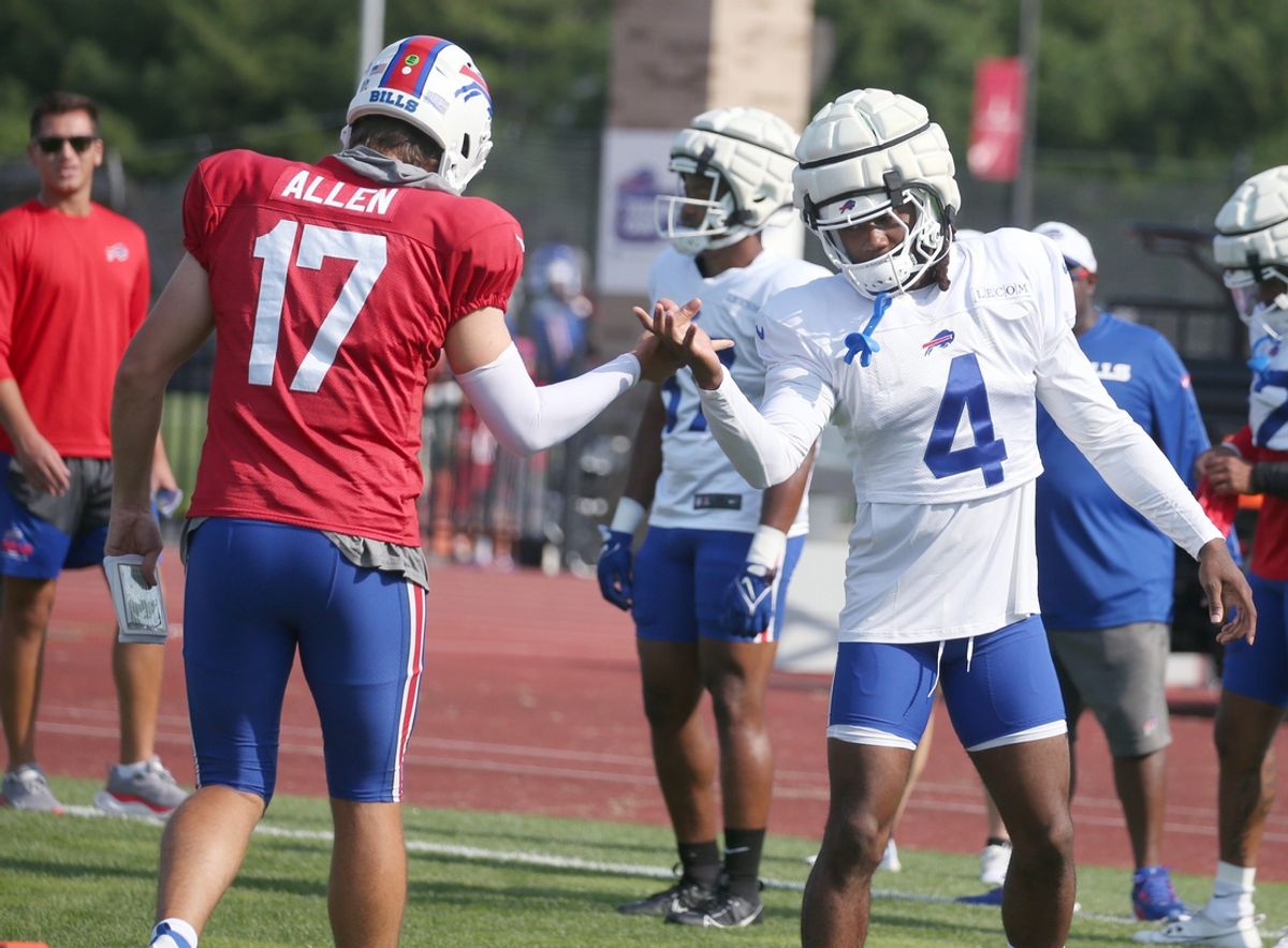 Bills quarterback Josh Allen works on the unique handshake with running back James Cook during day five.