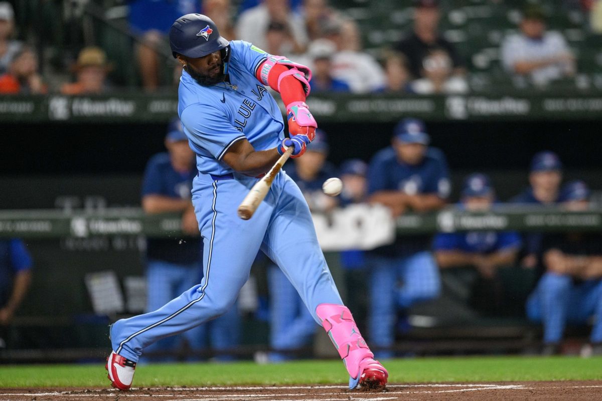 Jul 29, 2024; Baltimore, Maryland, USA; Toronto Blue Jays first base Vladimir Guerrero Jr. (27) hits a double during the first inning against the Baltimore Orioles at Oriole Park at Camden Yards. Mandatory Credit: Reggie Hildred-USA TODAY Sports