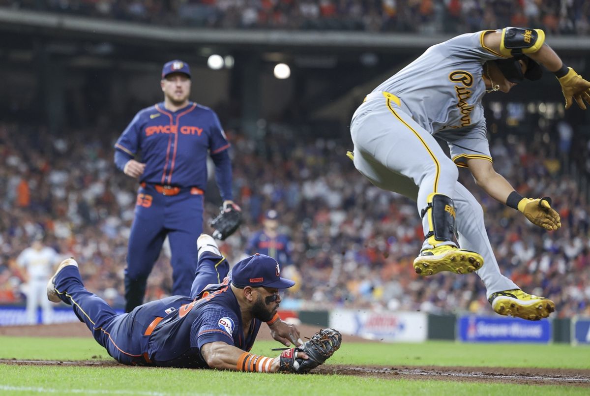 Jul 29, 2024; Houston, Texas, USA; Pittsburgh Pirates center fielder Ji Hwan Bae (3) is out after a play by Houston Astros first baseman Jon Singleton (28) at first base during the sixth inning at Minute Maid Park. Mandatory Credit: Troy Taormina-USA TODAY Sports