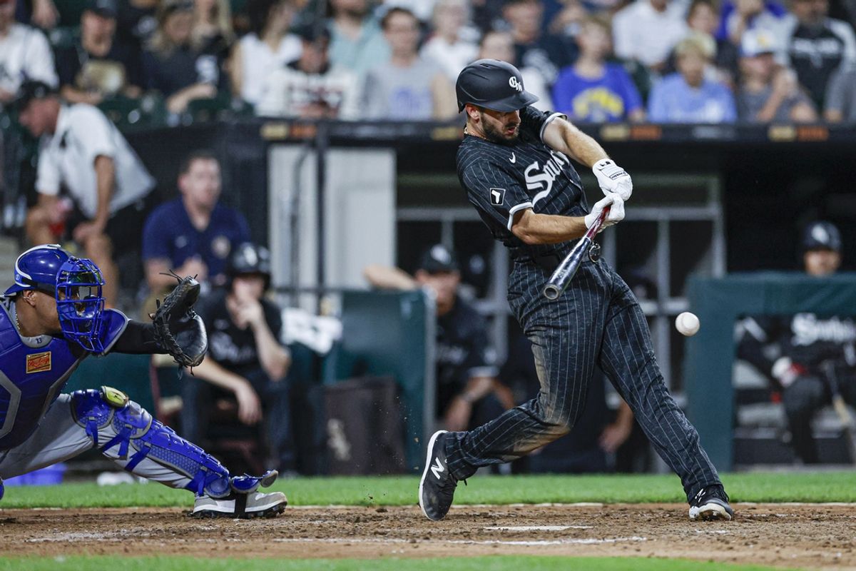 Jul 28, 2024; Chicago, Illinois, USA; Chicago White Sox shortstop Paul DeJong (29) hits an RBI-single against the Kansas City Royals during the sixth inning at Guaranteed Rate Field. Mandatory Credit: Kamil Krzaczynski-USA TODAY Sports