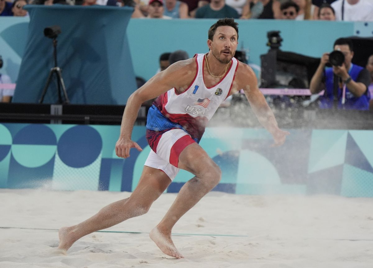 Jul 30, 2024; Paris, France; Miles Evans (USA) in action against the Netherlands in a beach volleyball preliminary match during the Paris 2024 Olympic Summer Games at Eiffel Tower Stadium. Mandatory Credit: Katie Goodale-USA TODAY Sports