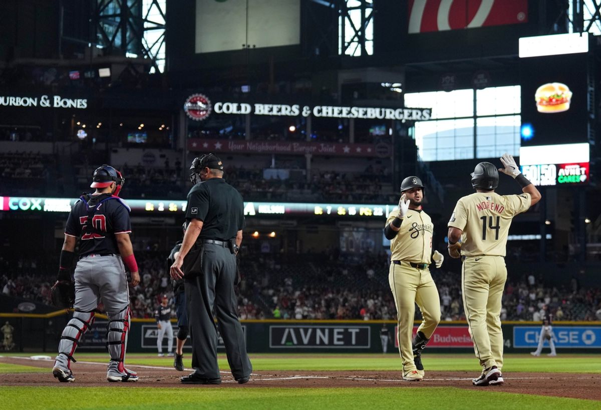Jul 30, 2024; Phoenix, Arizona, USA; Arizona Diamondbacks third base Eugenio Suárez (28) slaps hands with Arizona Diamondbacks catcher Gabriel Moreno (14) after hitting a two run home run against the Washington Nationals during the first inning at Chase Field. Mandatory Credit: Joe Camporeale-USA TODAY Sports