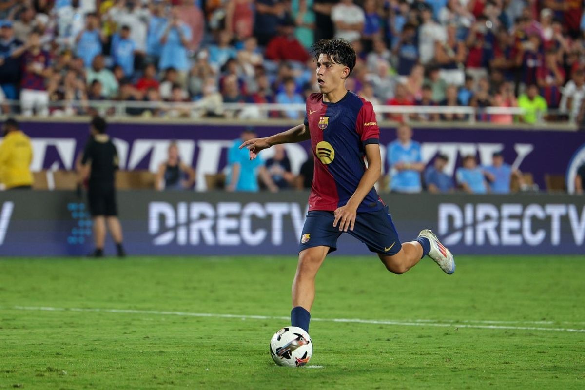 Jul 30, 2024; Orlando, FL, USA; Barcelona forward Lamine Yamal (27) makes a penalty kick against Manchester City in a tie breaker during a Champions Tour friendly match at Camping World Stadium. Mandatory Credit: Nathan Ray Seebeck-Imagn Images
