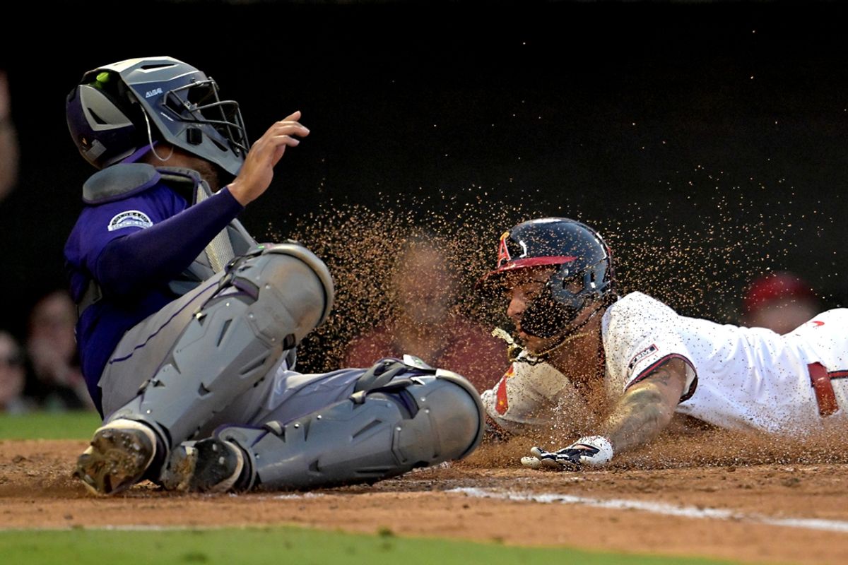 Jul 30, 2024; Anaheim, California, USA;  Los Angeles Angels shortstop Zach Neto (9) beats the tag by Colorado Rockies catcher Elias Diaz (35) for a run in the third inning at Angel Stadium. Mandatory Credit: Jayne Kamin-Oncea-USA TODAY Sports