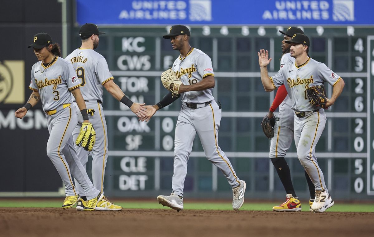 Jul 30, 2024; Houston, Texas, USA; Pittsburgh Pirates center fielder Michael A. Taylor (18) celebrates with teammates after the game against the Houston Astros at Minute Maid Park. Mandatory Credit: Troy Taormina-USA TODAY Sports