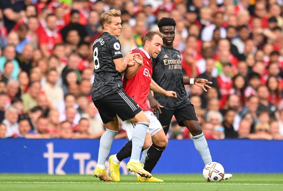Man United’s Christian Eriksen is fouled by Arsenal’s Martin O degaard during the Premier League match between Manchester United and Arsenal FC at Old Trafford.