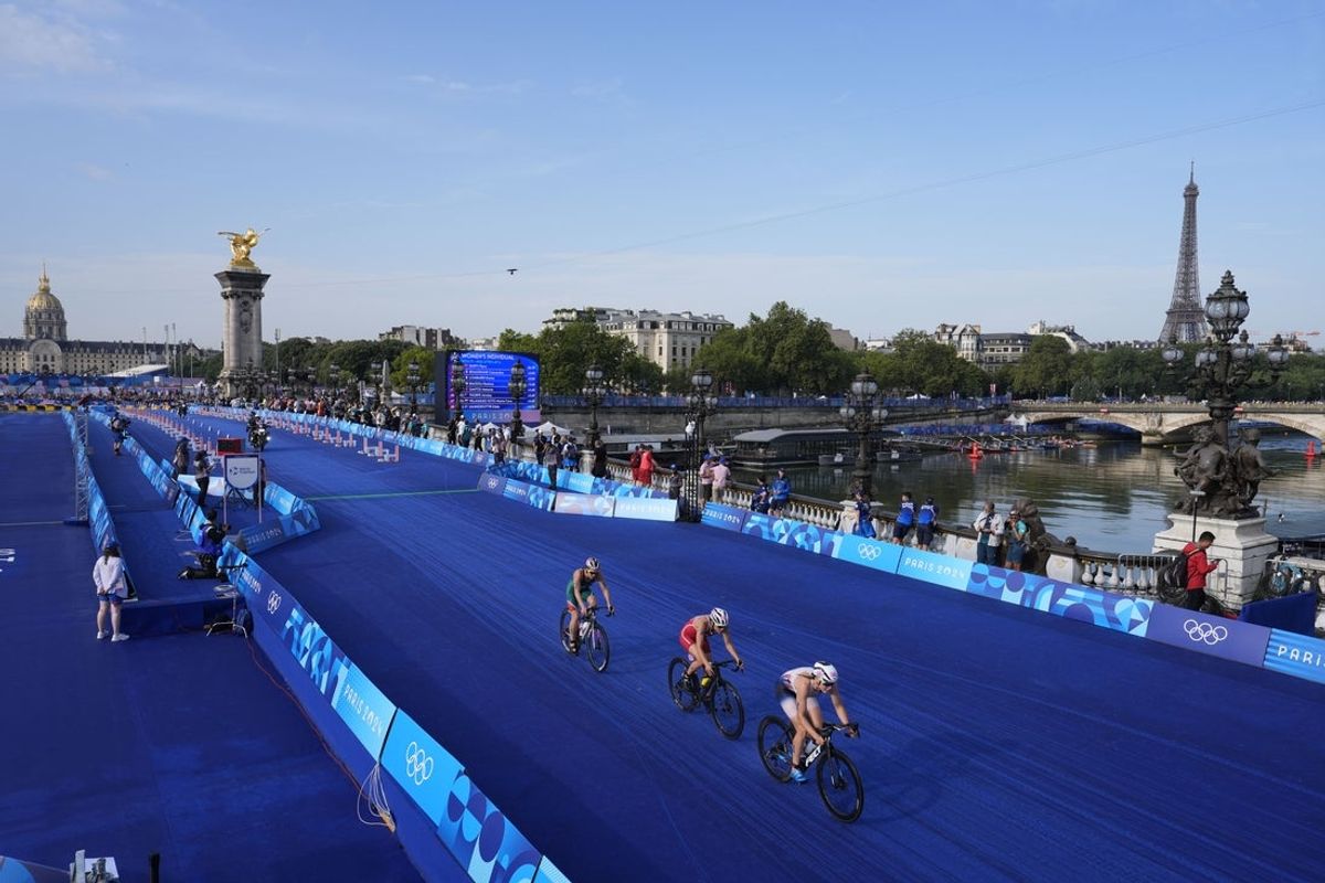 Jul 31, 2024; Paris, France; A general view as athletes including Solveig Lovseth (NOR) ride over the Pont Alexandre III bridge in the women's triathlon during the Paris 2024 Olympic Summer Games. Mandatory Credit: Andrew Nelles-Imagn Images