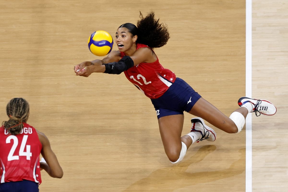 Jul 31, 2024; Paris, France; United States opposite Jordan Thompson (12) dives for the ball against Serbia in a pool A match during the Paris 2024 Olympic Summer Games at South Paris Arena 1. Mandatory Credit: Yukihito Taguchi-USA TODAY Sports