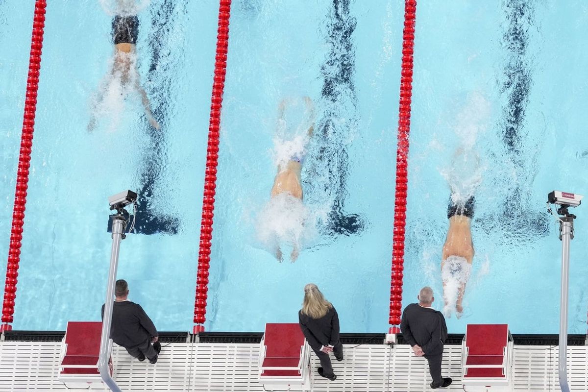 Jul 31, 2024; Nanterre, France; Ilya Kharun (Canada), Kristof Milak (Hungary) and Leon Marchand (France) in the men’s 200-meter butterfly final during the Paris 2024 Olympic Summer Games at Paris La Défense Arena. Mandatory Credit: Rob Schumacher-Imagn Images
