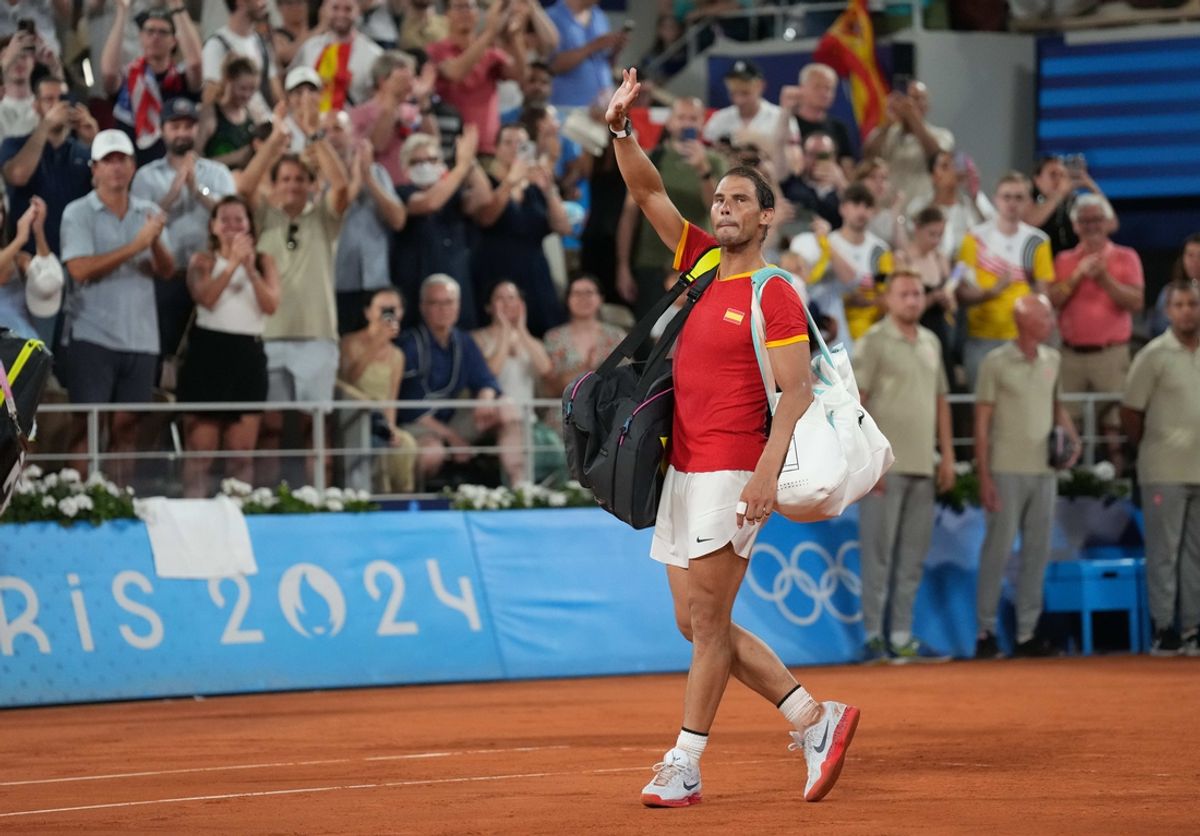 Jul 31, 2024; Paris, France; Rafael Nadal (ESP) waves to the crowd after losing to Austin Krajicek and Rajeev Ram (USA) in a men's doubles quarterfinal tennis match during the Paris 2024 Olympic Summer Games at Stade Roland Garros. Mandatory Credit: Kirby Lee-Imagn Images