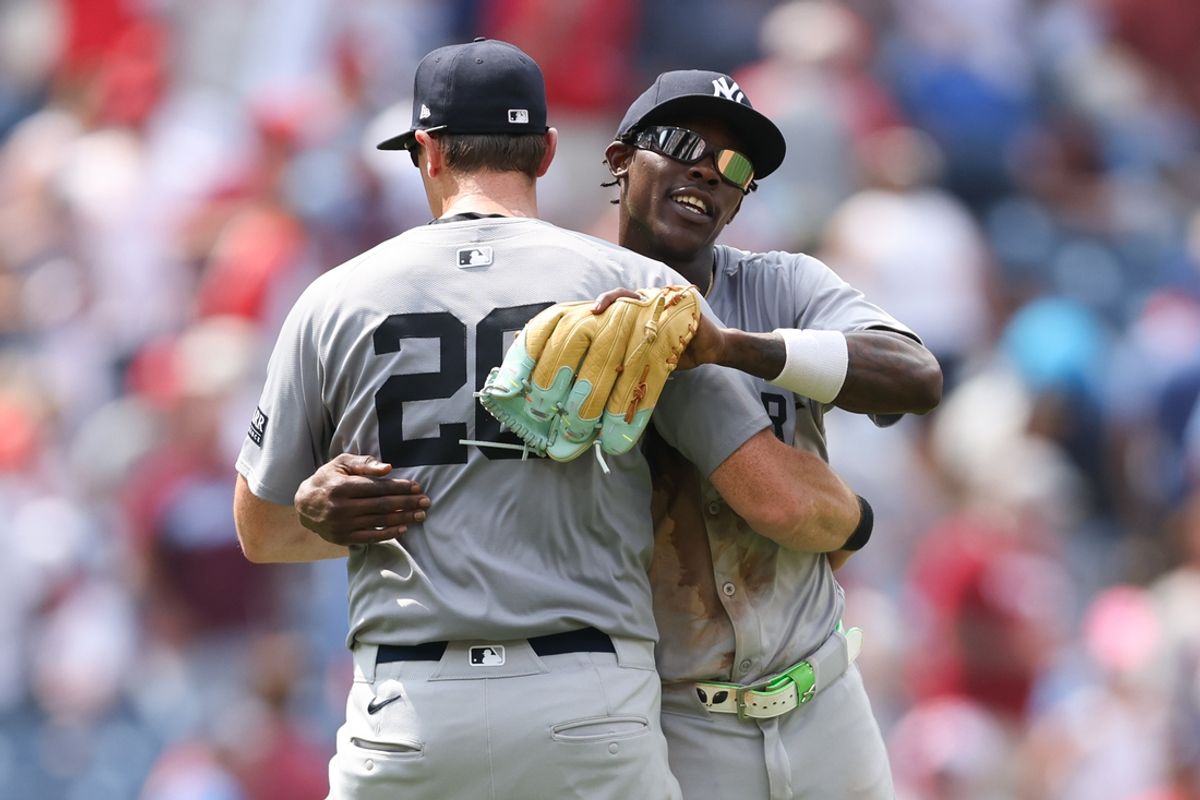 Jul 31, 2024; Philadelphia, Pennsylvania, USA;  New York Yankees third base DJ LeMahieu (26) and third base Jazz Chisholm Jr. (13) celebrate a victory against the Philadelphia Phillies at Citizens Bank Park. Mandatory Credit: Bill Streicher-USA TODAY Sports