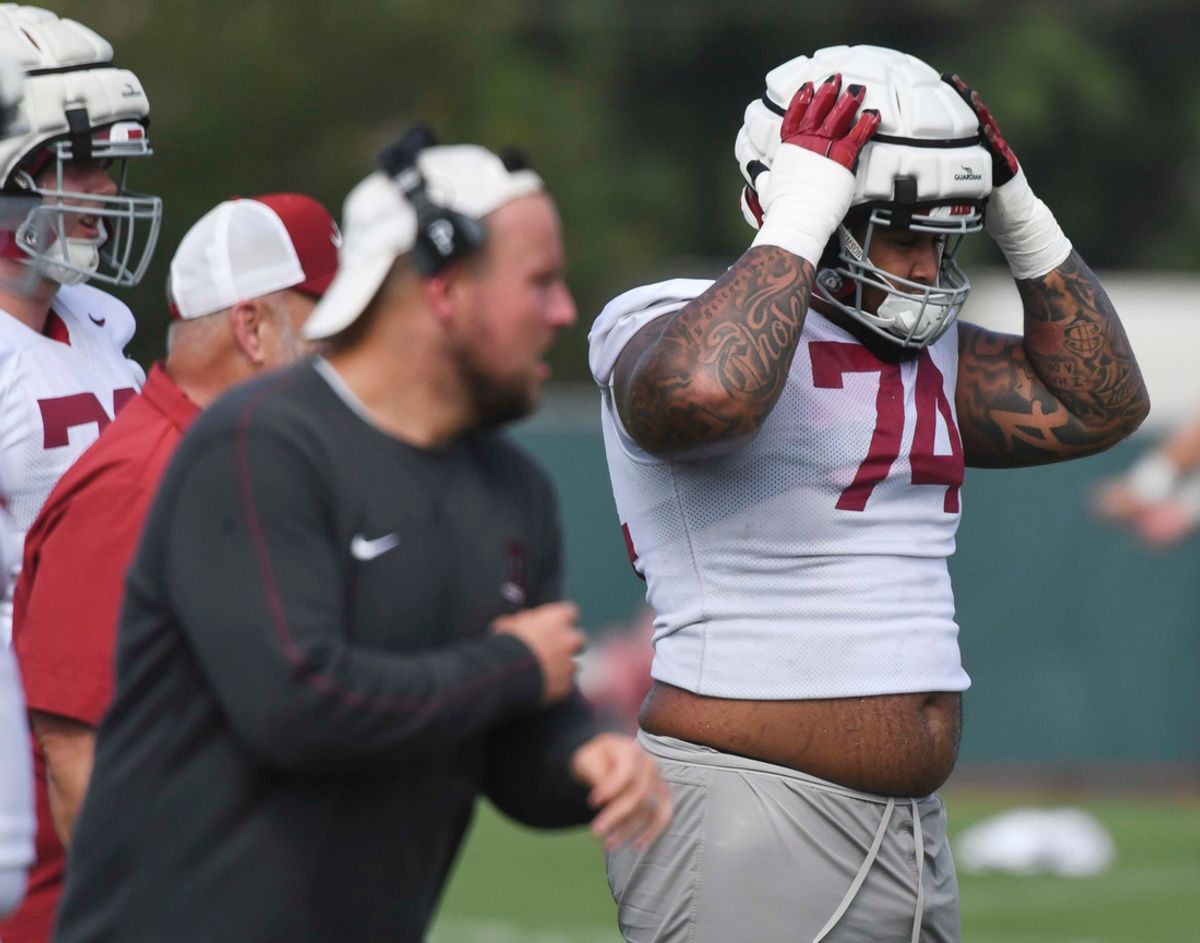 The Crimson Tide football team continued practice Thursday, Aug. 1, 2024, as they prepare for the season opener and the first game under new head coach Kalen DeBoer. Alabama offensive lineman Kadyn Proctor (74) secures his helmet during practice.