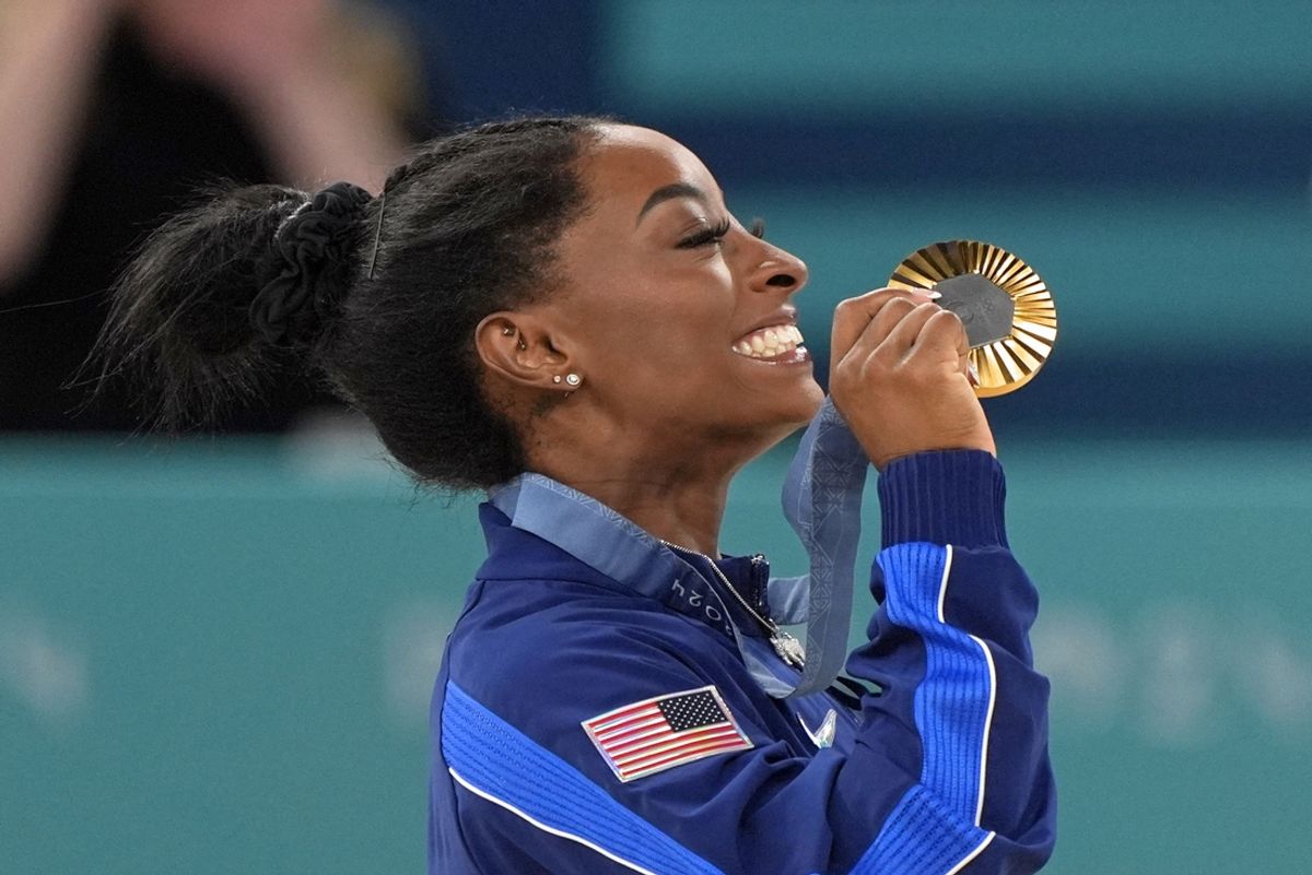 Aug 1, 2024; Paris, France; Simone Biles of the United States celebrates her gold medal in the womenís gymnastics all-around during the Paris 2024 Olympic Summer Games at Bercy Arena. Mandatory Credit: Jack Gruber-USA TODAY Sports