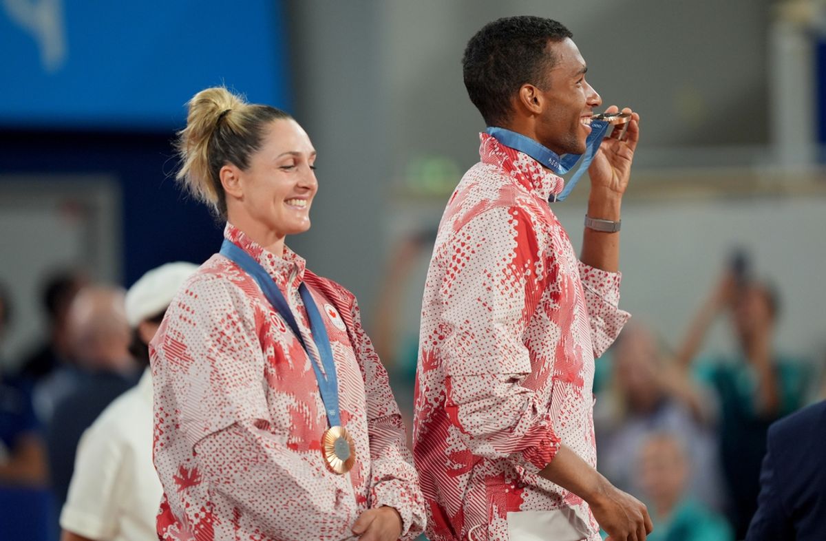 Aug 2, 2024; Paris, France; Gabriela Dabrowski (CAN) and Felix Auger-Aliassime celebrate after winning the bronze medal in mixed doubles during the Paris 2024 Olympic Summer Games at Stade Roland Garros. Mandatory Credit: Amber Searls-Imagn Images