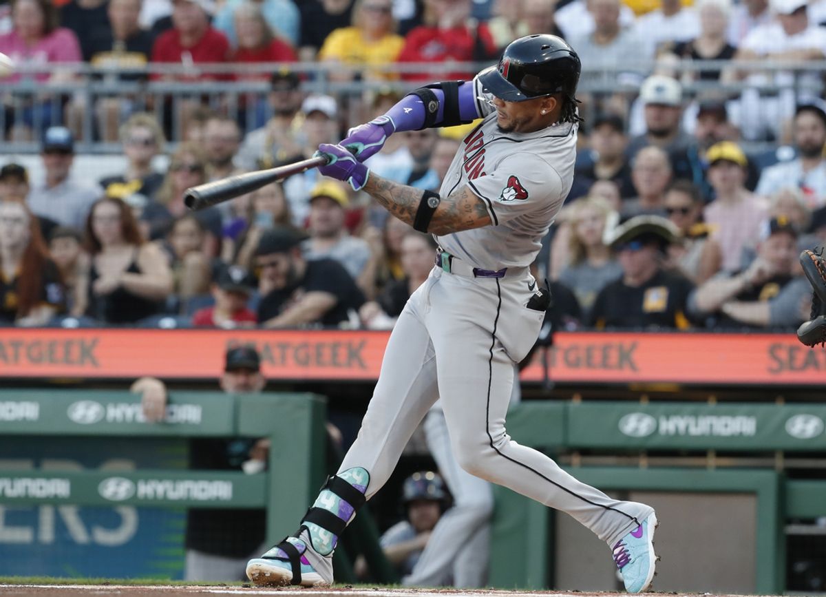 Aug 2, 2024; Pittsburgh, Pennsylvania, USA;  Arizona Diamondbacks second baseman Ketel Marte (4) hits a solo home run against the Pittsburgh Pirates during the first inning at PNC Park. Mandatory Credit: Charles LeClaire-USA TODAY Sports