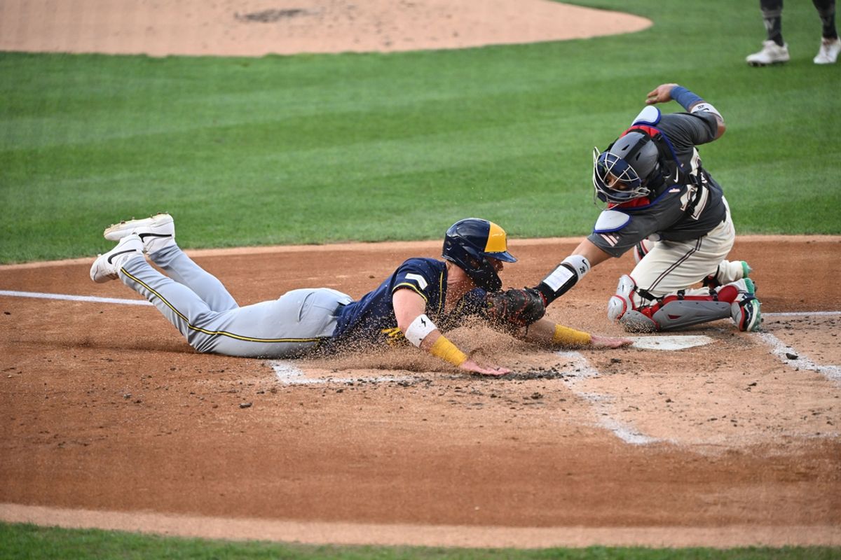 Aug 2, 2024; Washington, District of Columbia, USA; Milwaukee Brewers first baseman Jake Bauers (9) dives safely into home for a run in front of Washington Nationals catcher Keibert Ruiz (20) during the second inning at Nationals Park. Mandatory Credit: Rafael Suanes-USA TODAY Sports