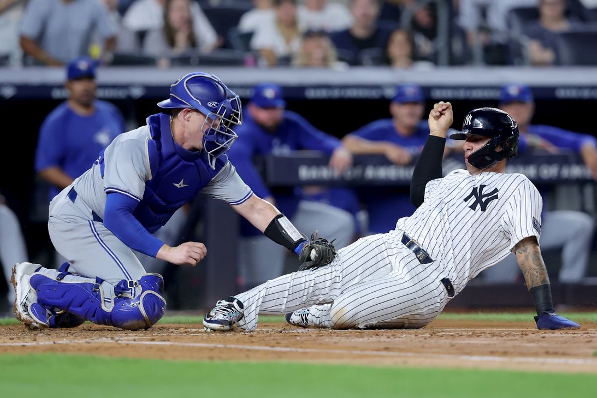 Aug 2, 2024; Bronx, New York, USA; Toronto Blue Jays catcher Brian Serven (15) tags out New York Yankees second baseman Gleyber Torres (25) trying to score on a base hit by Yankees shortstop Anthony Volpe (not pictured) during the second inning at Yankee Stadium. Mandatory Credit: Brad Penner-USA TODAY Sports
