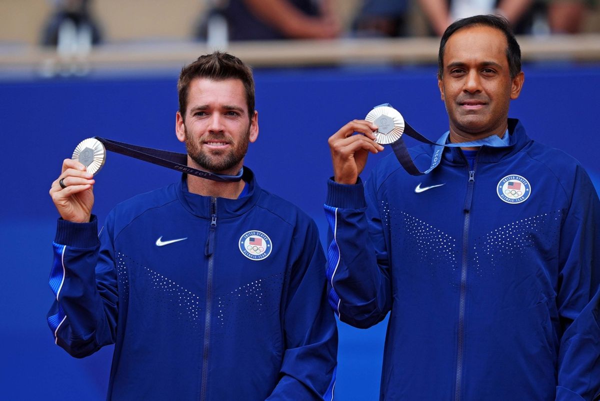 Aug 3, 2024; Paris, France; Austin Krajicek (USA) and Rajeev Ram (USA) celebrate winning the silver medal in men’s doubles tennis during the Paris 2024 Olympic Summer Games at Stade Roland Garros. Mandatory Credit: Amber Searls-Imagn Images.