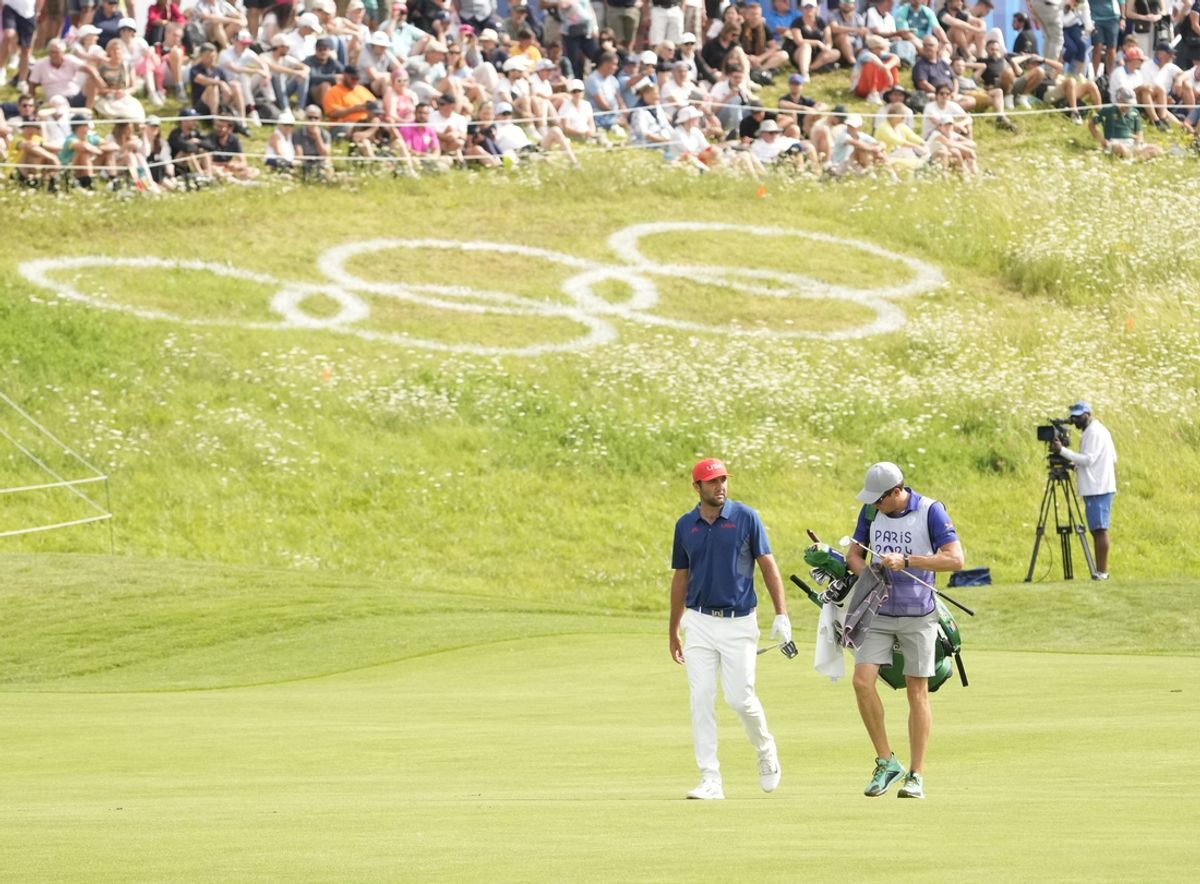 Aug 3, 2024; Saint-Quentin-en-Yvelines, France; Scottie Scheffler walks the 18th fairway in the third round of men's golf stroke play during the Paris 2024 Olympic Summer Games at Le Golf National. Mandatory Credit: Michael Madrid-USA TODAY Sports