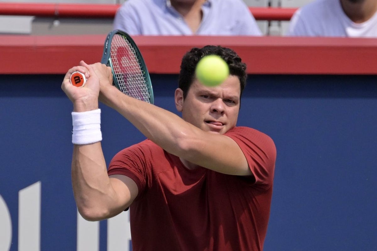 Aug 3, 2024; Montreal, Quebec, Canada; Milos Raonic (CAN) hits a backhand during practice at IGA Stadium. Mandatory Credit: Eric Bolte-Imagn Images