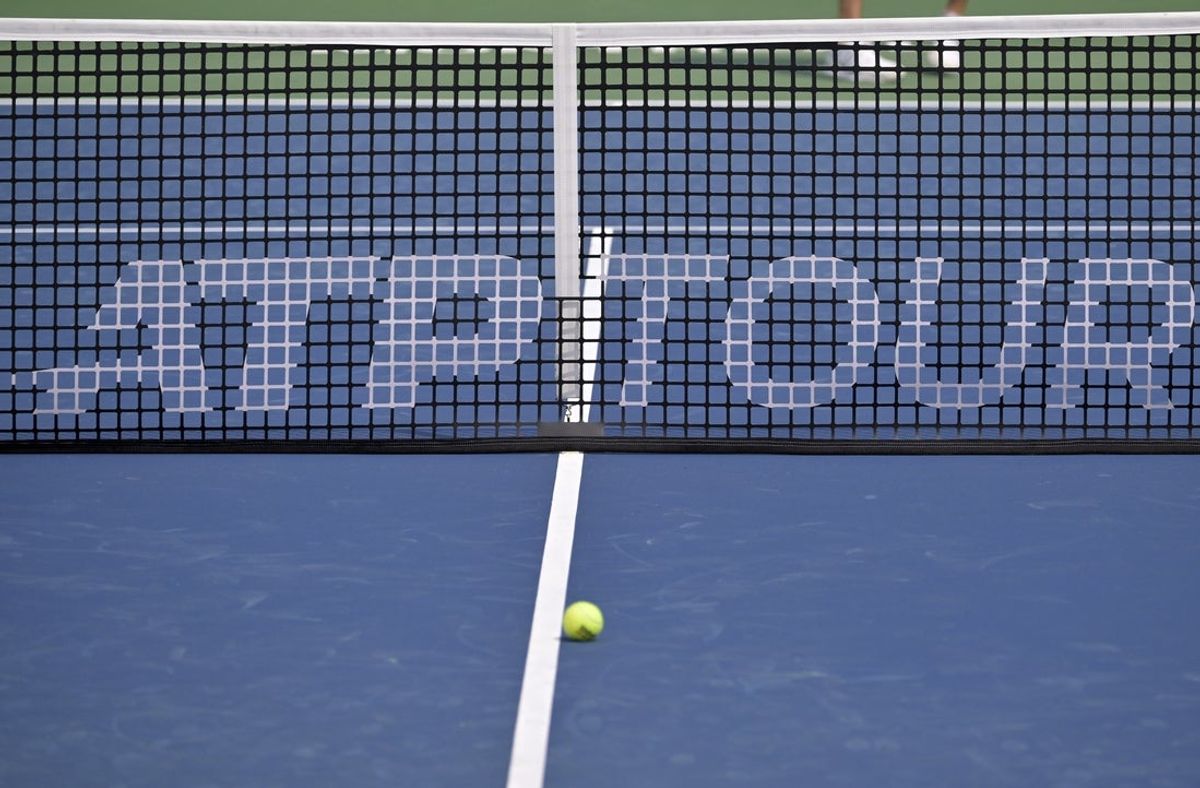 Aug 3, 2024; Montreal, Quebec, Canada; ATP Tour marking on the net at centre court during practice at IGA Stadium. Mandatory Credit: Eric Bolte-Imagn Images