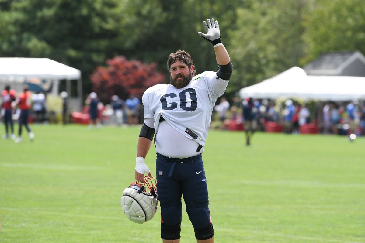 Aug 03, 2024; Foxborough, MA, USA; New England Patriots center David Andrews (60) waves to his son at training camp at Gillette Stadium. Mandatory Credit: Eric Canha-Imagn Images