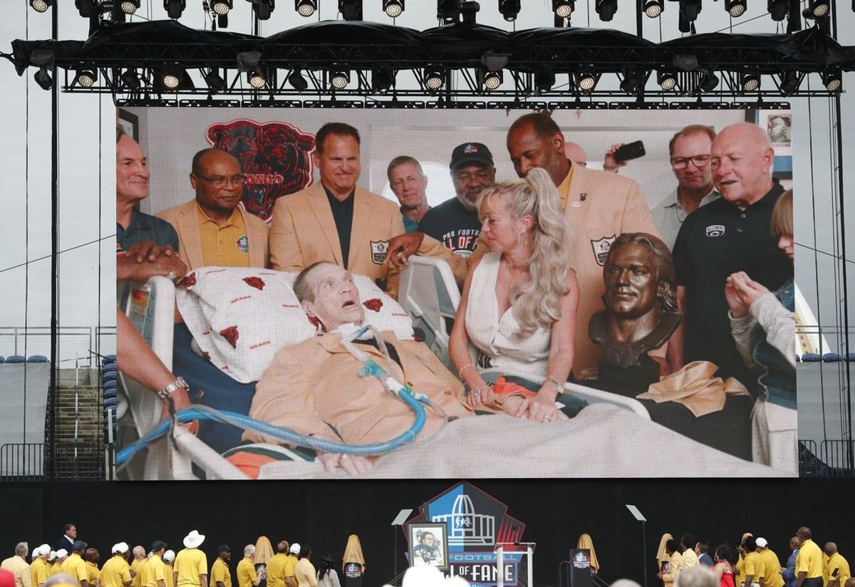 Aug 3, 2024; Canton, OH, USA;  A video is played of Steve McMichael during his induction into the Pro Football Hall of Fame at the enshrinement ceremony at Tom Benson Hall of Fame Stadium. McMichael was unable to attend in person. Mandatory Credit: Charles LeClaire-Imagn Images
