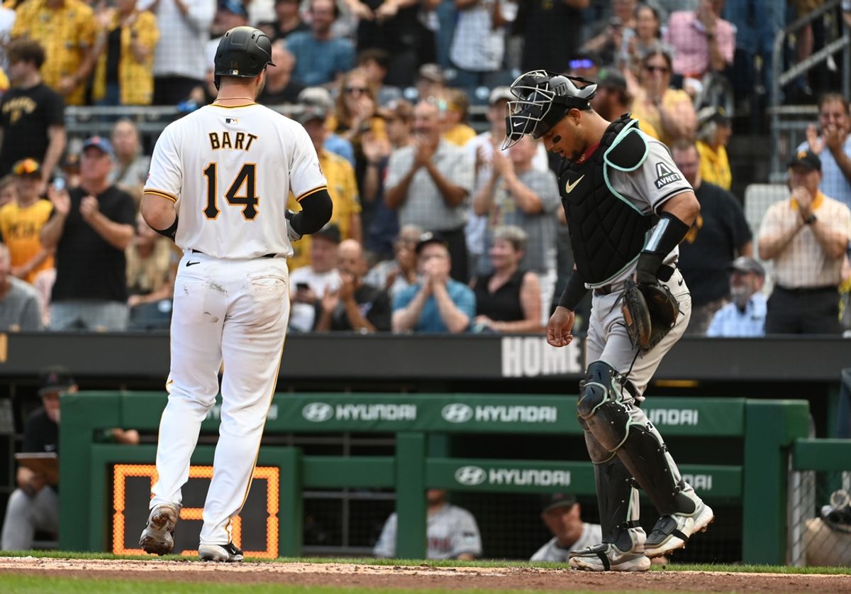 Aug 3, 2024; Pittsburgh, Pennsylvania, USA;  Pittsburgh Pirates batter Joey Bart (14) crosses home plate in front of Arizona Diamondbacks catcher Gabriel Moreno(14) after hitting a solo home run in the second inning at PNC Park. Mandatory Credit: Philip G. Pavely-USA TODAY Sports
