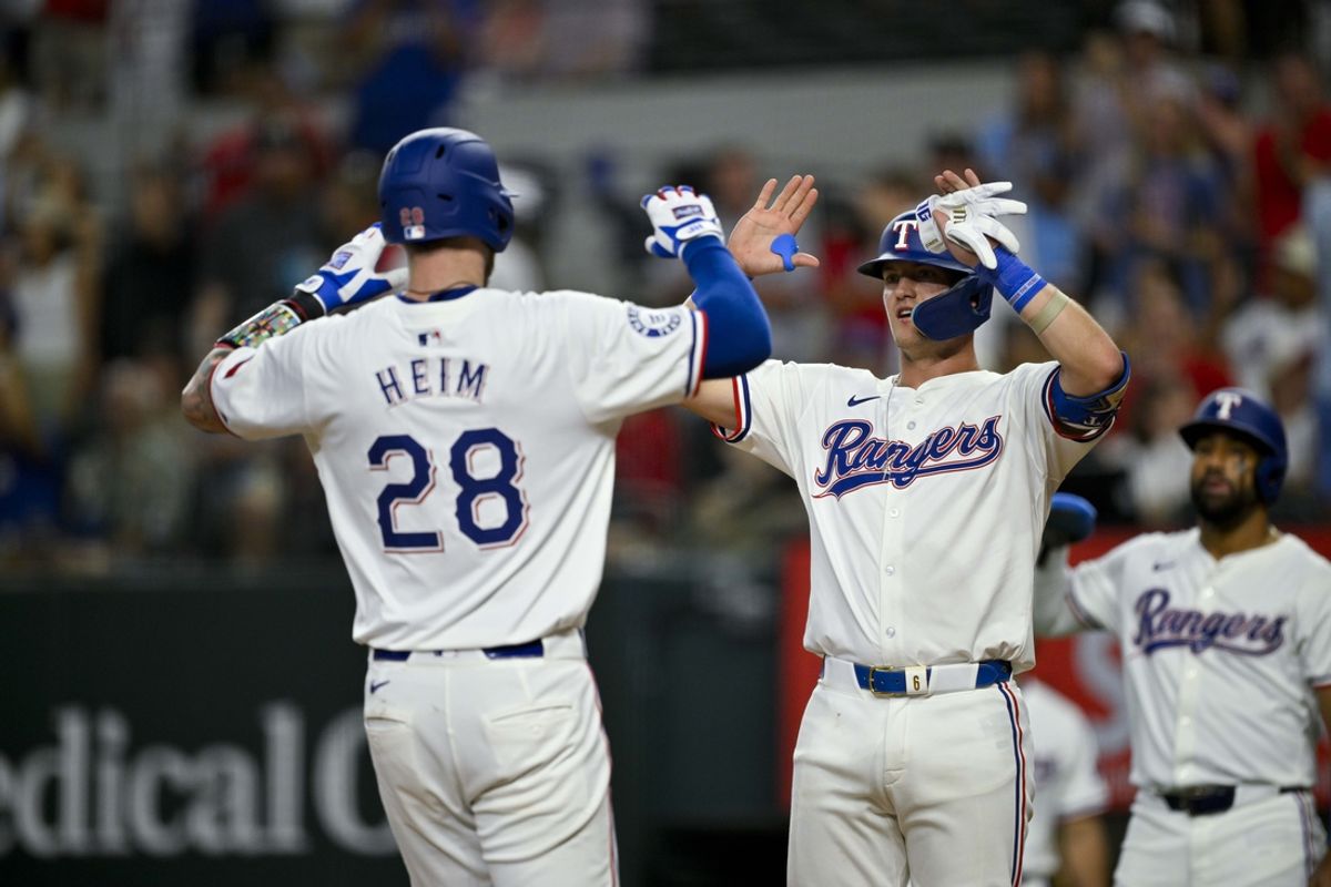 Aug 3, 2024; Arlington, Texas, USA;  Texas Rangers catcher Jonah Heim (28) and third baseman Josh Jung (6) celebrate after Heim hits a three run home run against the Boston Red Sox during the fourth inning at Globe Life Field. Mandatory Credit: Jerome Miron-USA TODAY Sports