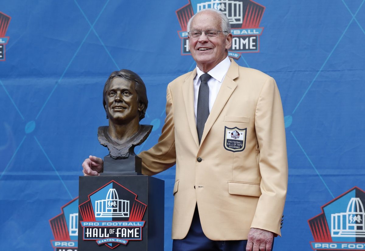 Aug 3, 2024; Canton, OH, USA; Pro Football Hall of Fame Class of 2024 member Randy Gradishar poses with his bust at his enshrinement ceremony at Tom Benson Hall of Fame Stadium. Mandatory Credit: Charles LeClaire-Imagn Images