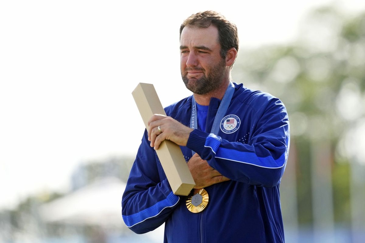 Aug 4, 2024; Saint-Quentin-en-Yvelines, France; Scottie Scheffler of Team United States reacts after winning the gold medal in menís individual stroke play during the Paris 2024 Olympic Summer Games at Le Golf National. Mandatory Credit: Michael Madrid-USA TODAY Sports