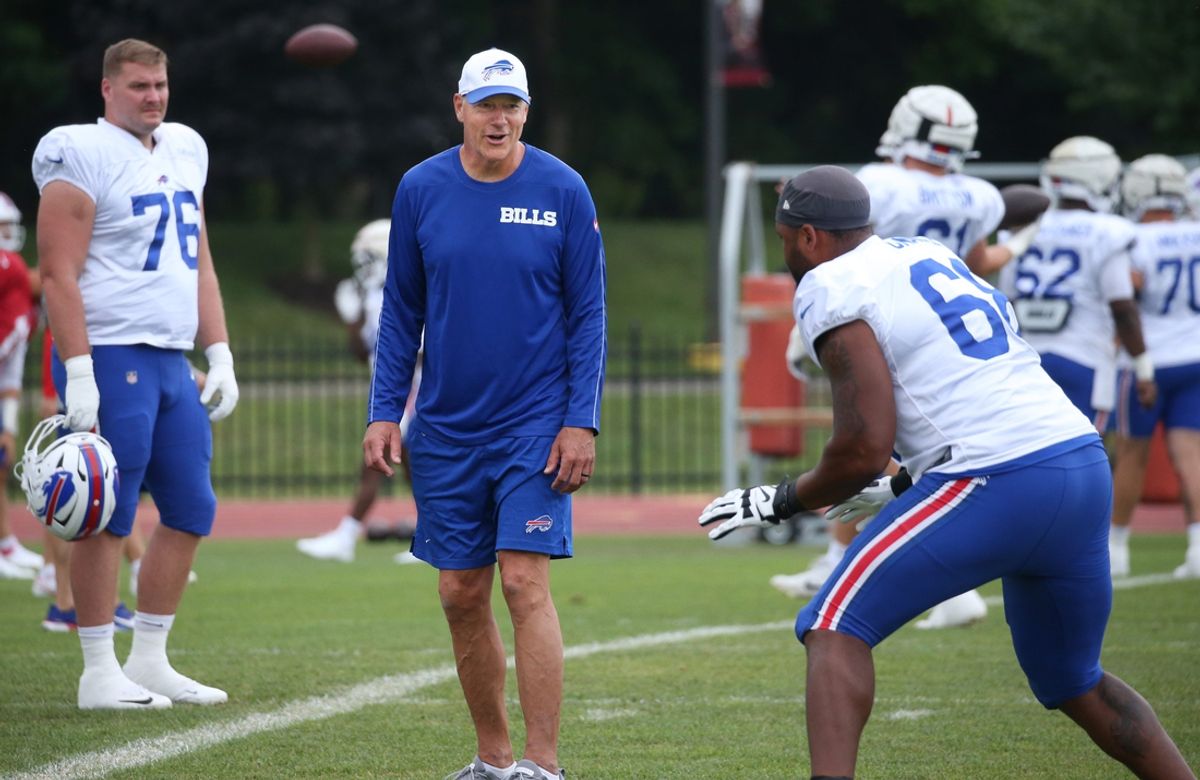 Buffalo Bills offensive line coach Aaron Kromer works with lineman Tylan Grable before the start of the Buffalo Bills training camp.
