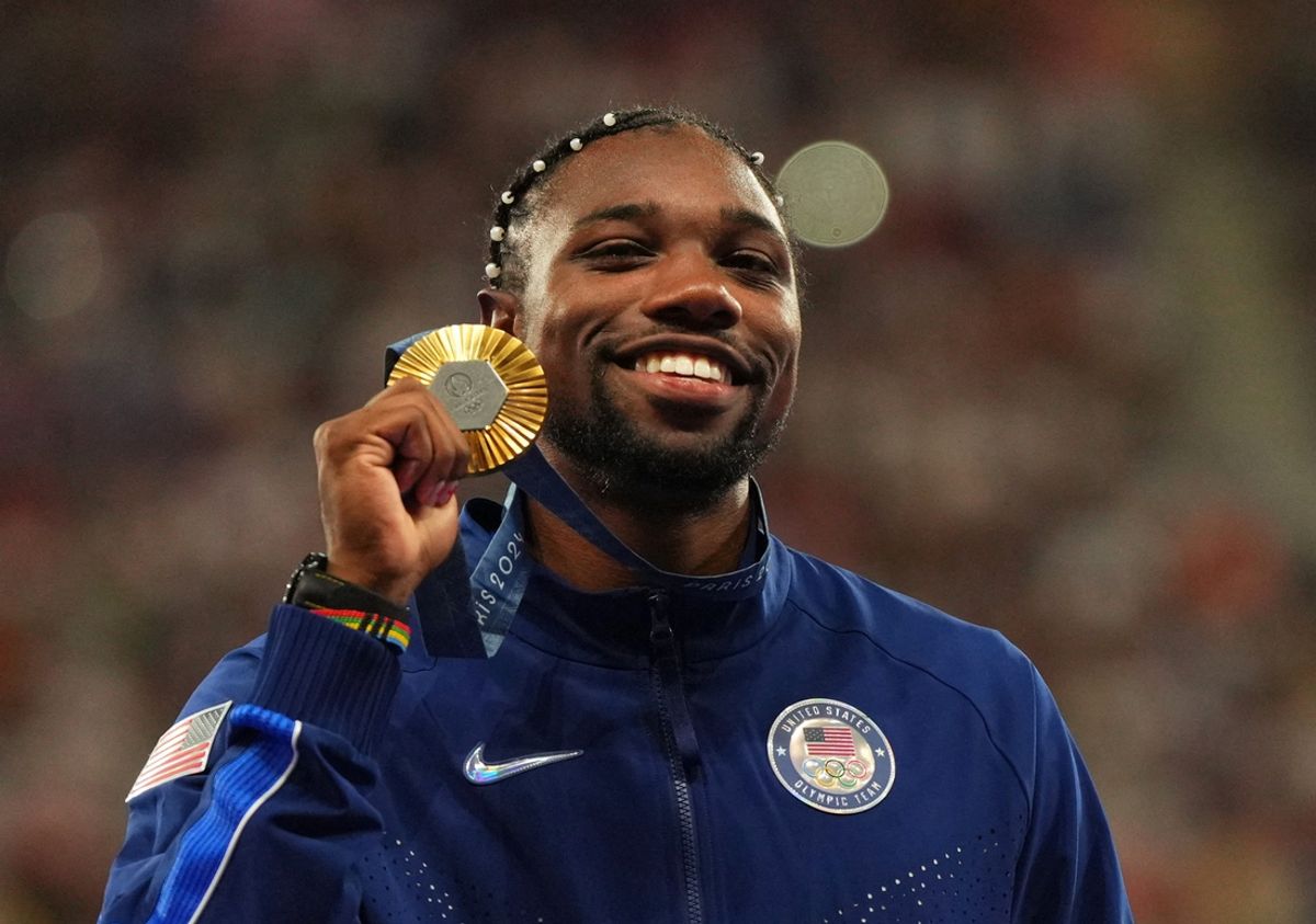 Aug 5, 2024; Paris Saint-Denis, France; Noah Lyles (USA) celebrates with his gold medal at the victory ceremony for the men's 100m during the Paris 2024 Olympic Summer Games at Stade de France.