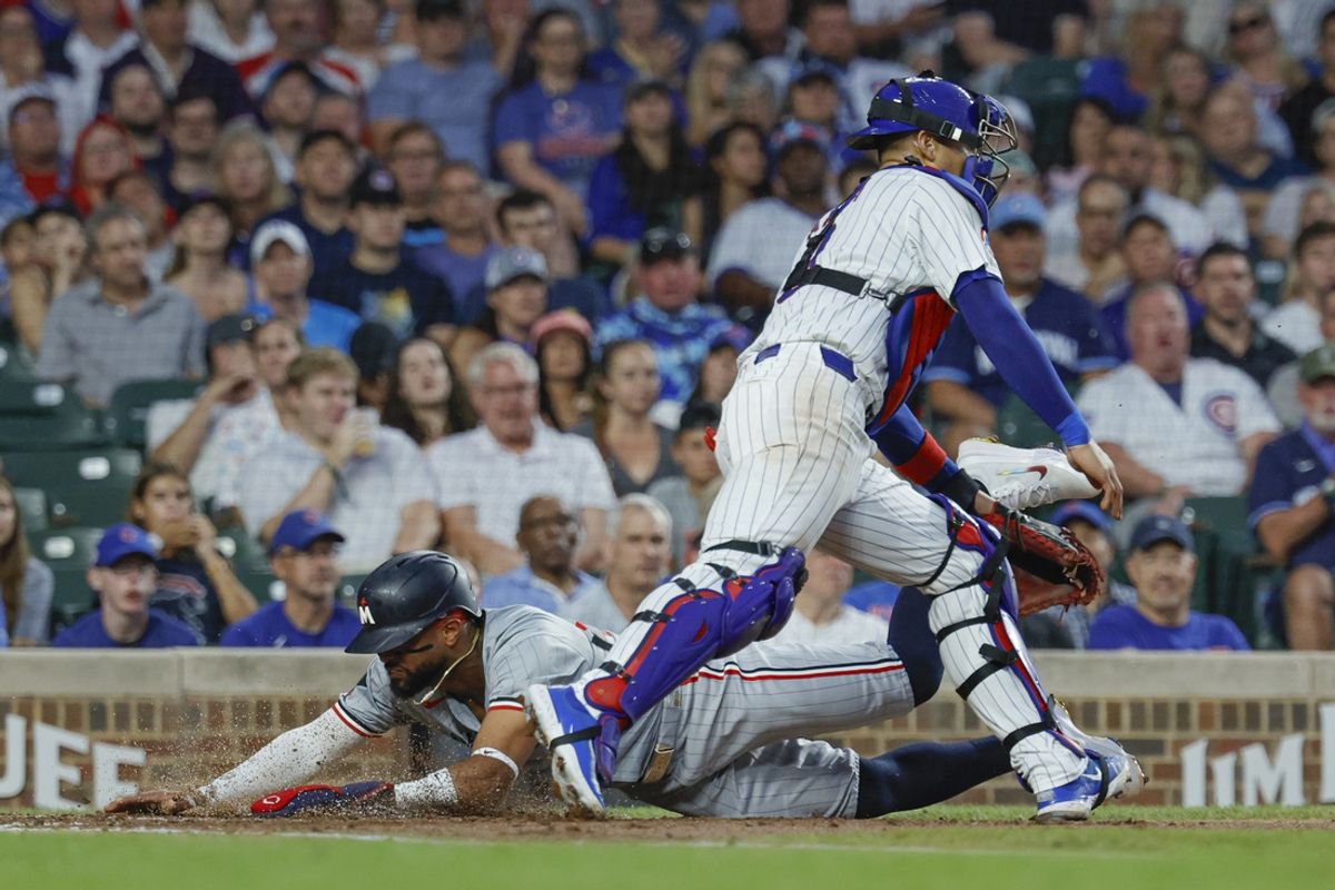 Aug 5, 2024; Chicago, Illinois, USA; Minnesota Twins second baseman Willi Castro (50) scores against Chicago Cubs catcher Miguel Amaya (9) during the third inning at Wrigley Field. Mandatory Credit: Kamil Krzaczynski-USA TODAY Sports